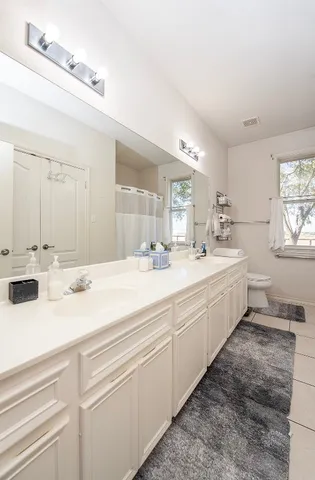 a bedroom with bed and a window