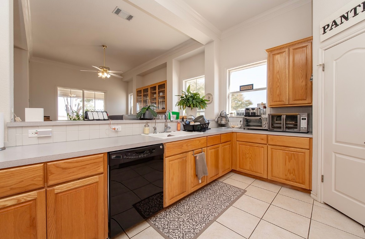 1833 County Road 305 Jarrell, TX 76537 - Photo 38 of 40 a kitchen with stainless steel appliances granite countertop a sink and cabinets