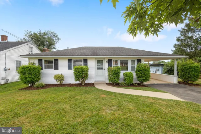 a front view of a house with a garden and yard