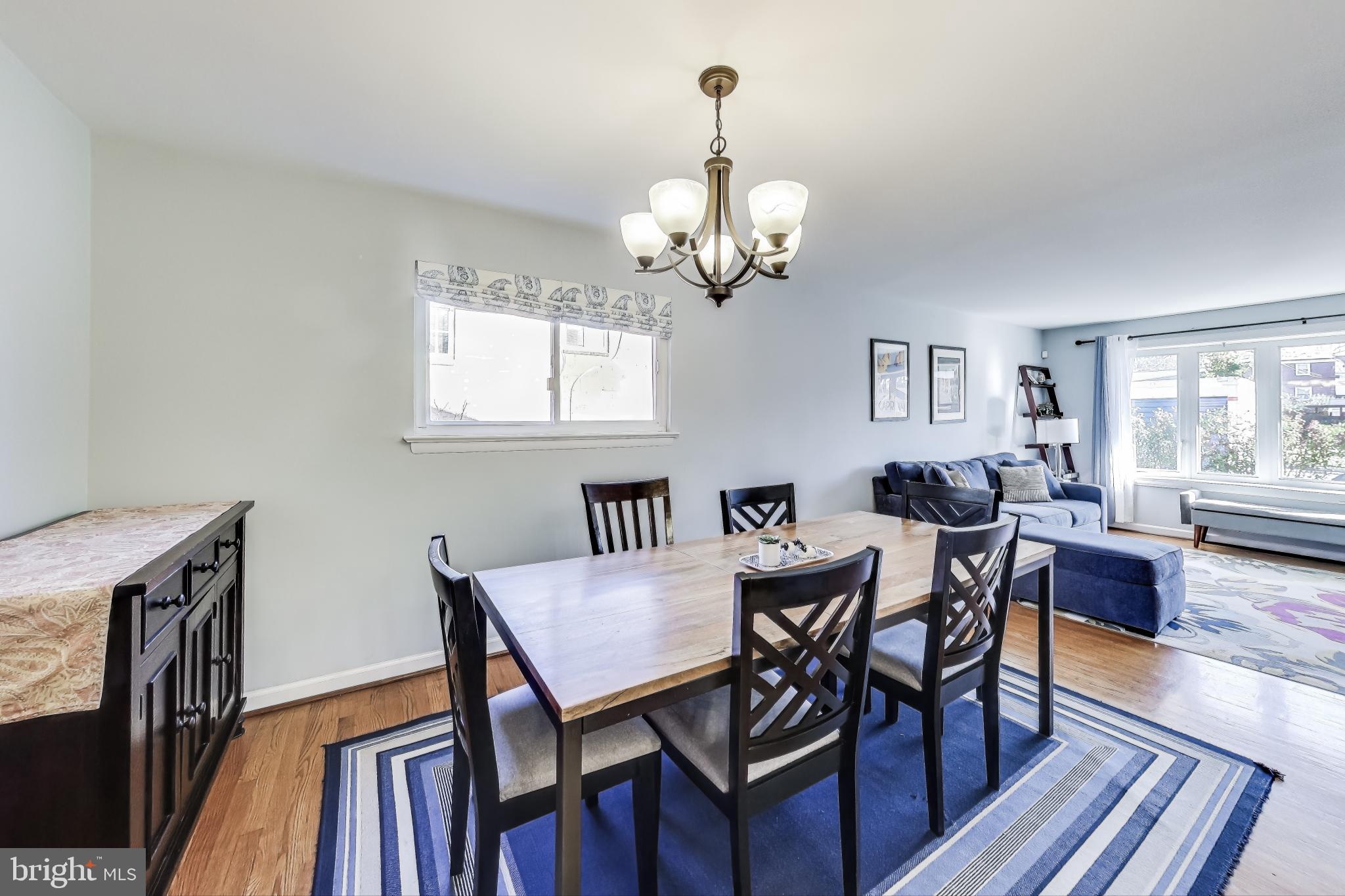 9512 Flower Avenue Silver Spring, MD 20901 - Photo 11 of 41 a view of a dining room with furniture a chandelier and wooden floor