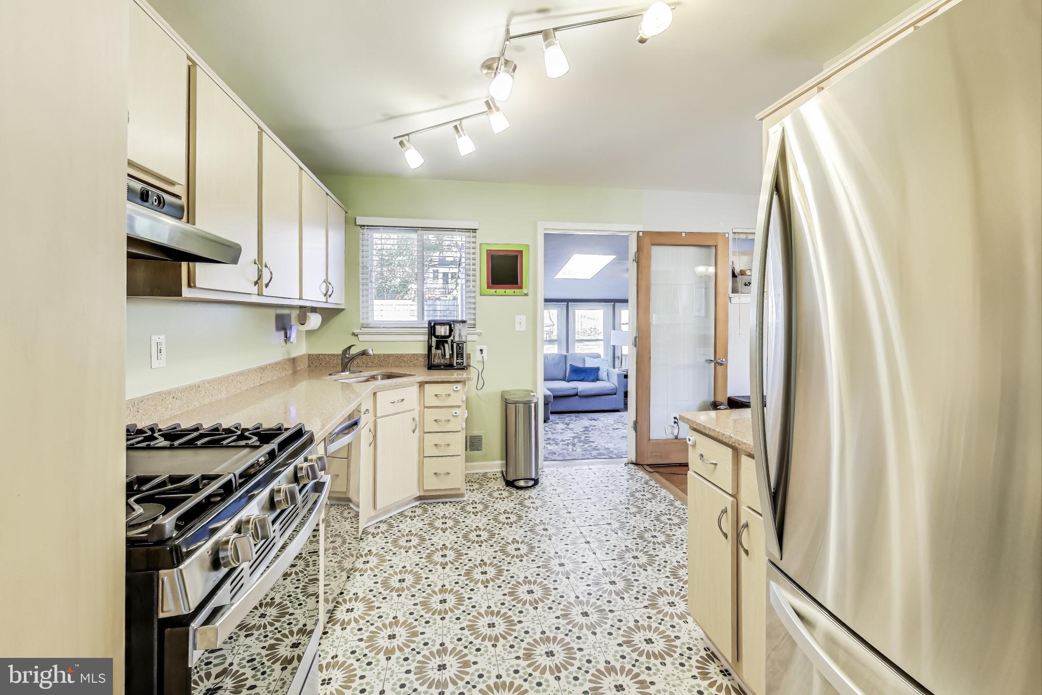 9512 Flower Avenue Silver Spring, MD 20901 - Photo 14 of 41 a kitchen with a wooden floor and a stove top oven
