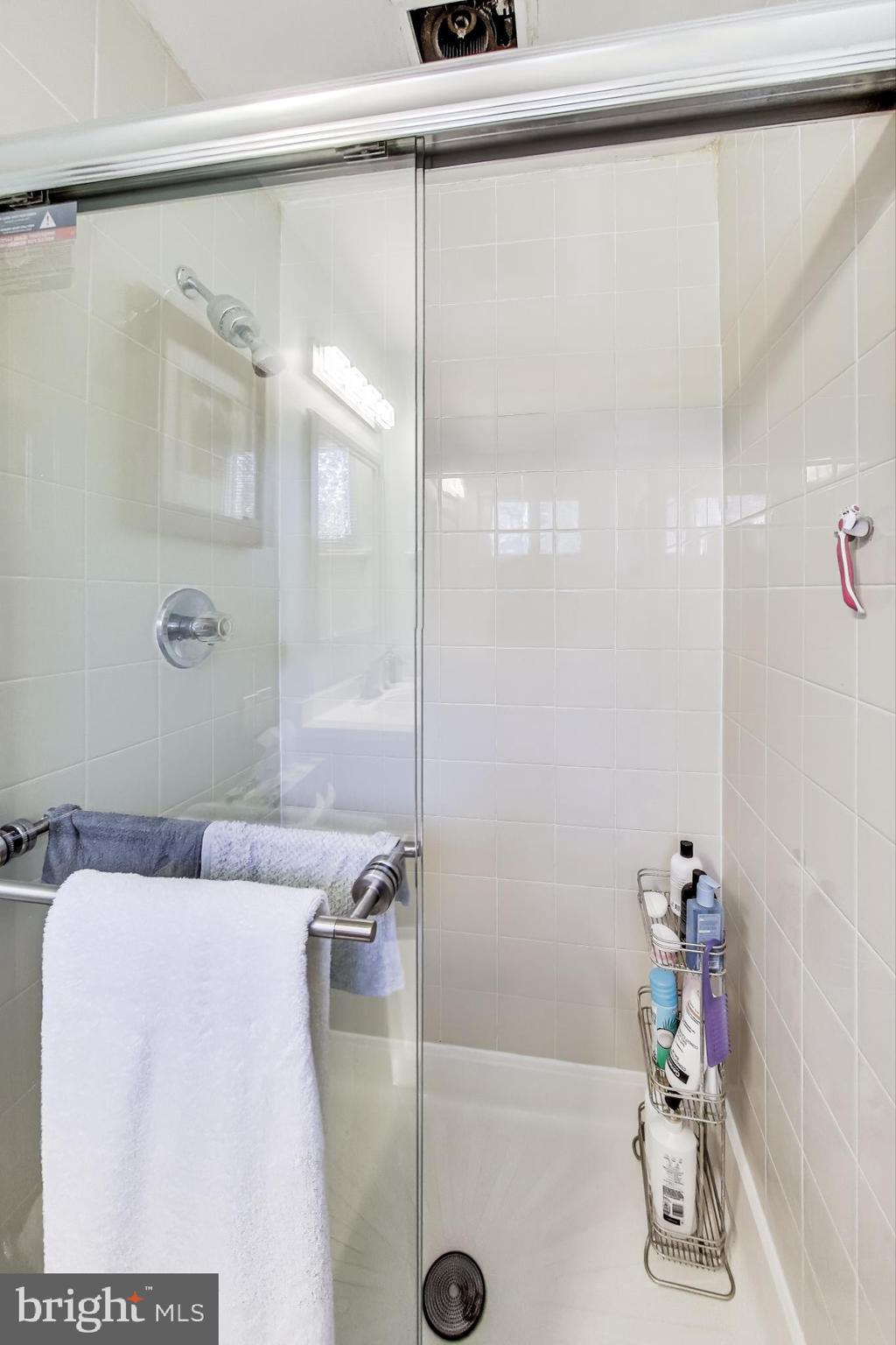 9512 Flower Avenue Silver Spring, MD 20901 - Photo 21 of 41 a bathroom with a shower and a mirror