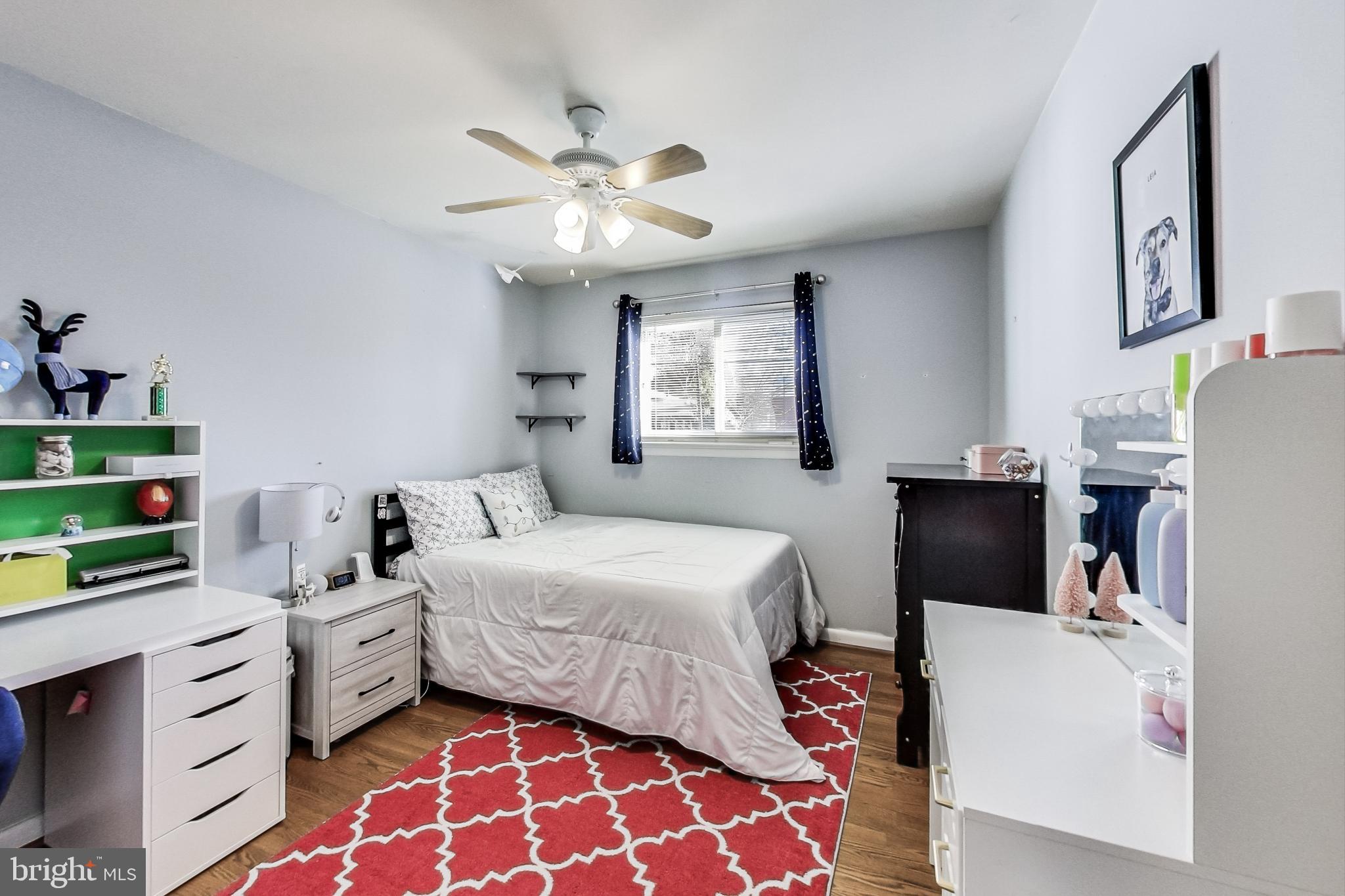 9512 Flower Avenue Silver Spring, MD 20901 - Photo 22 of 41 a bedroom with a bed and a chandelier