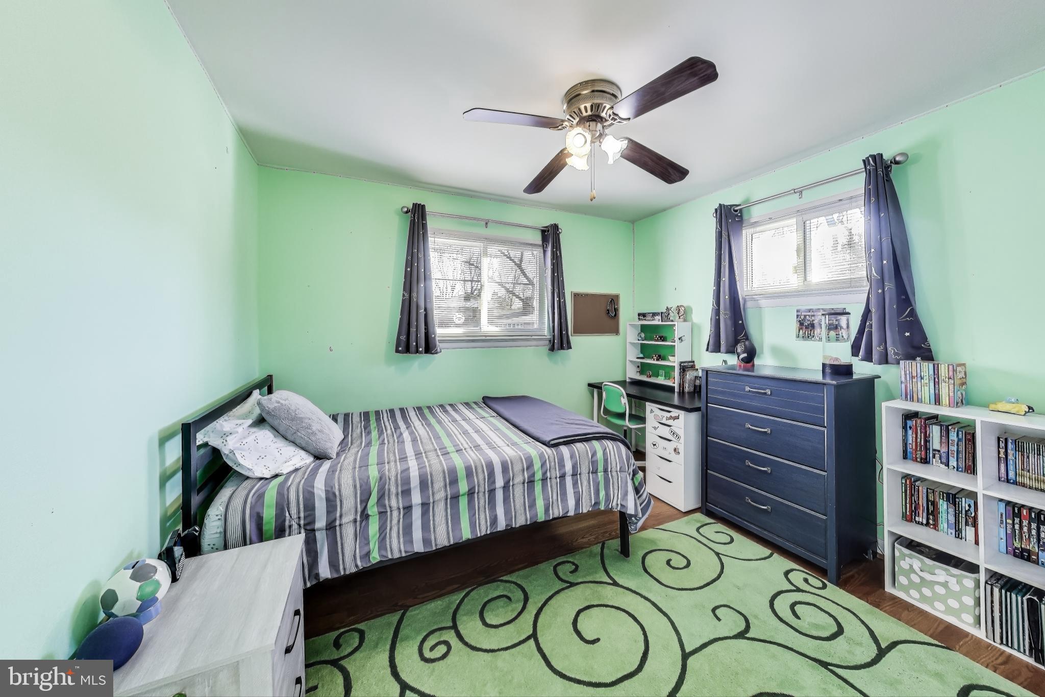 9512 Flower Avenue Silver Spring, MD 20901 - Photo 24 of 41 a bedroom with a bed and a bookshelf