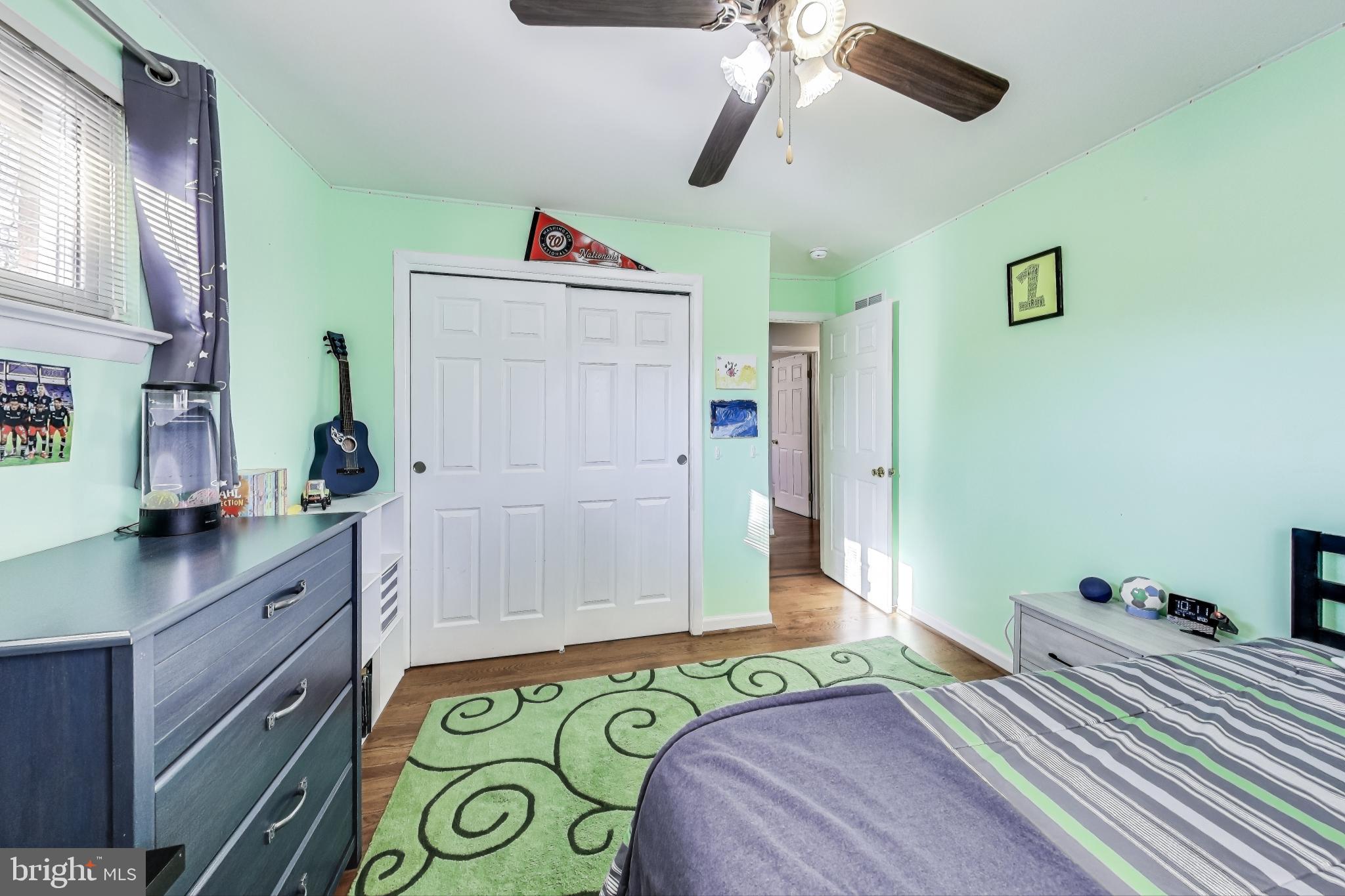 9512 Flower Avenue Silver Spring, MD 20901 - Photo 25 of 41 a bedroom with a bed and a chandelier