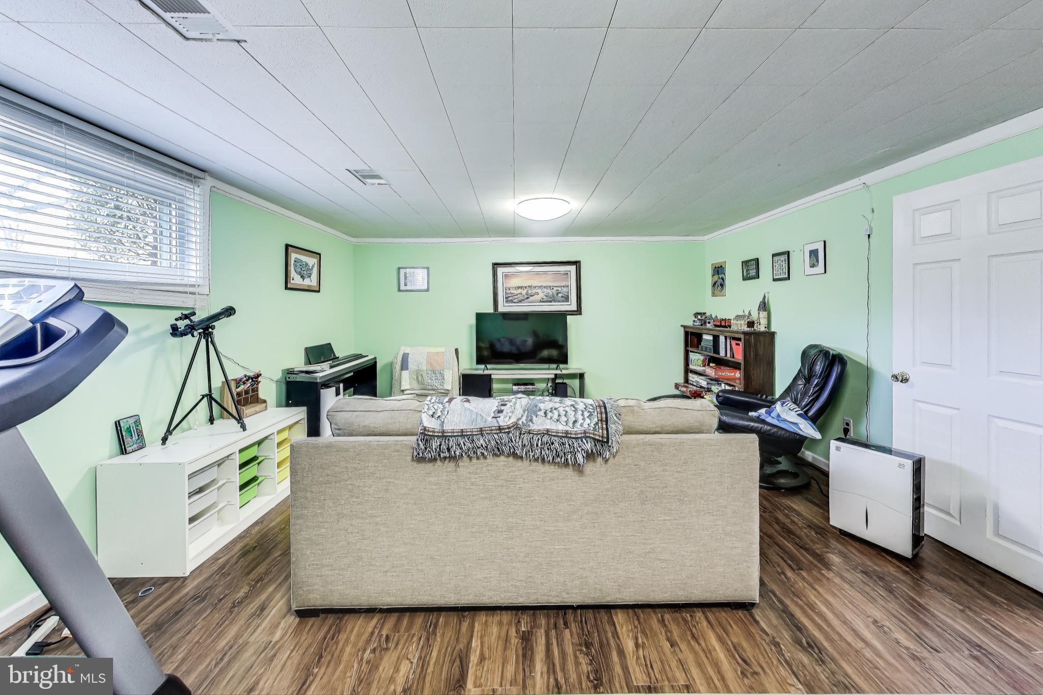 9512 Flower Avenue Silver Spring, MD 20901 - Photo 28 of 41 a living room with furniture and a flat screen tv