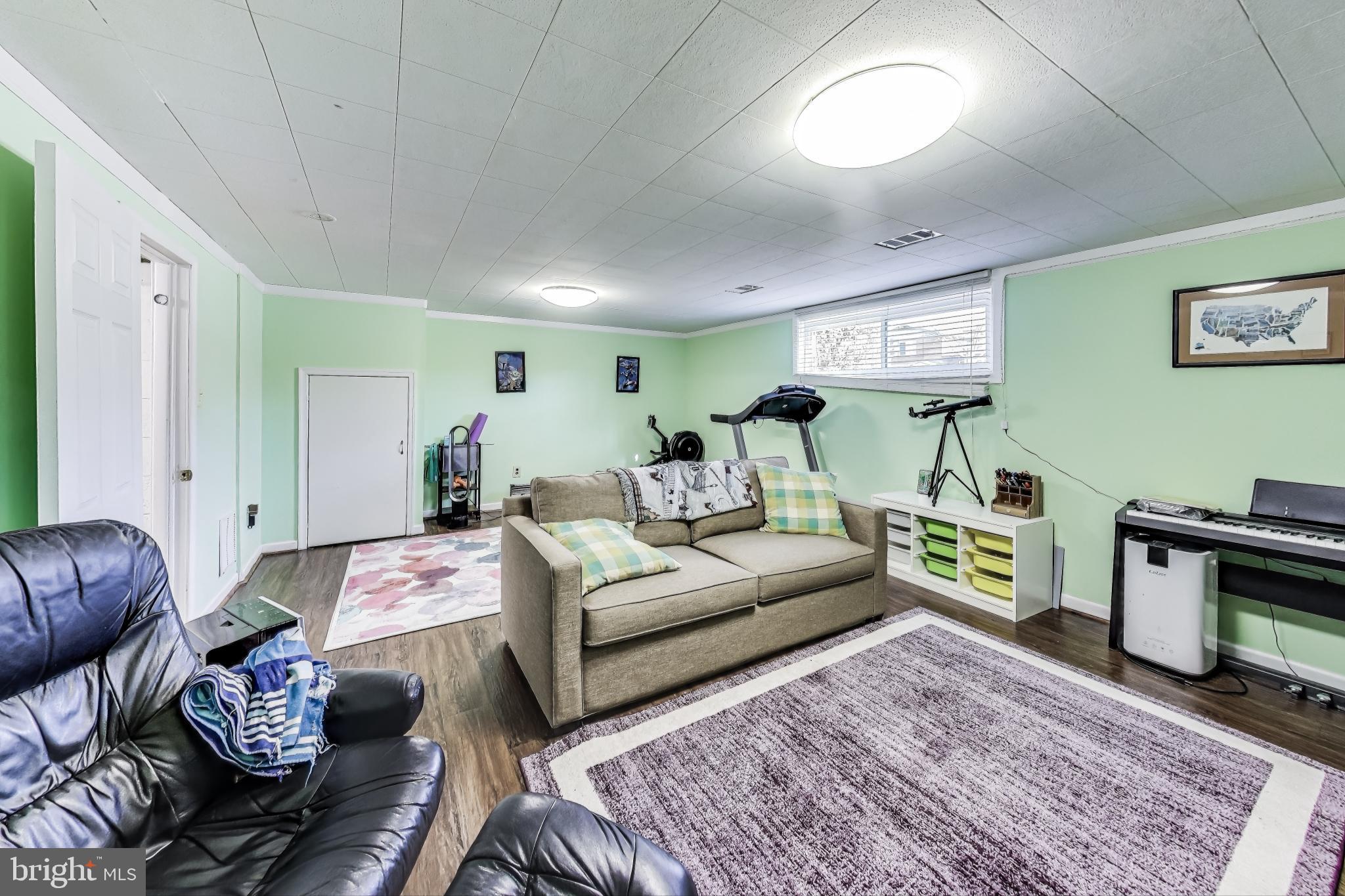 9512 Flower Avenue Silver Spring, MD 20901 - Photo 29 of 41 a living room with furniture and a wooden floor