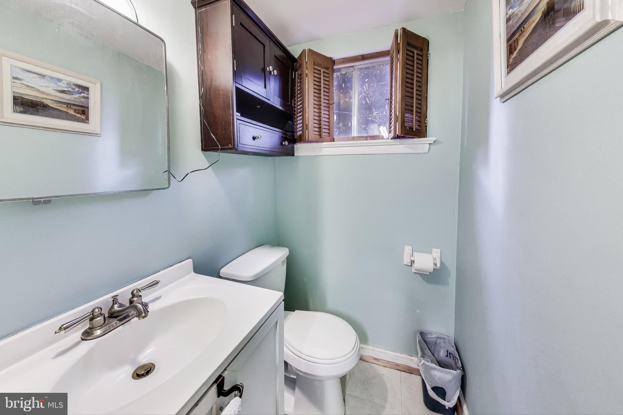 9512 Flower Avenue Silver Spring, MD 20901 - Photo 30 of 41 a white toilet sitting next to a bathroom sink