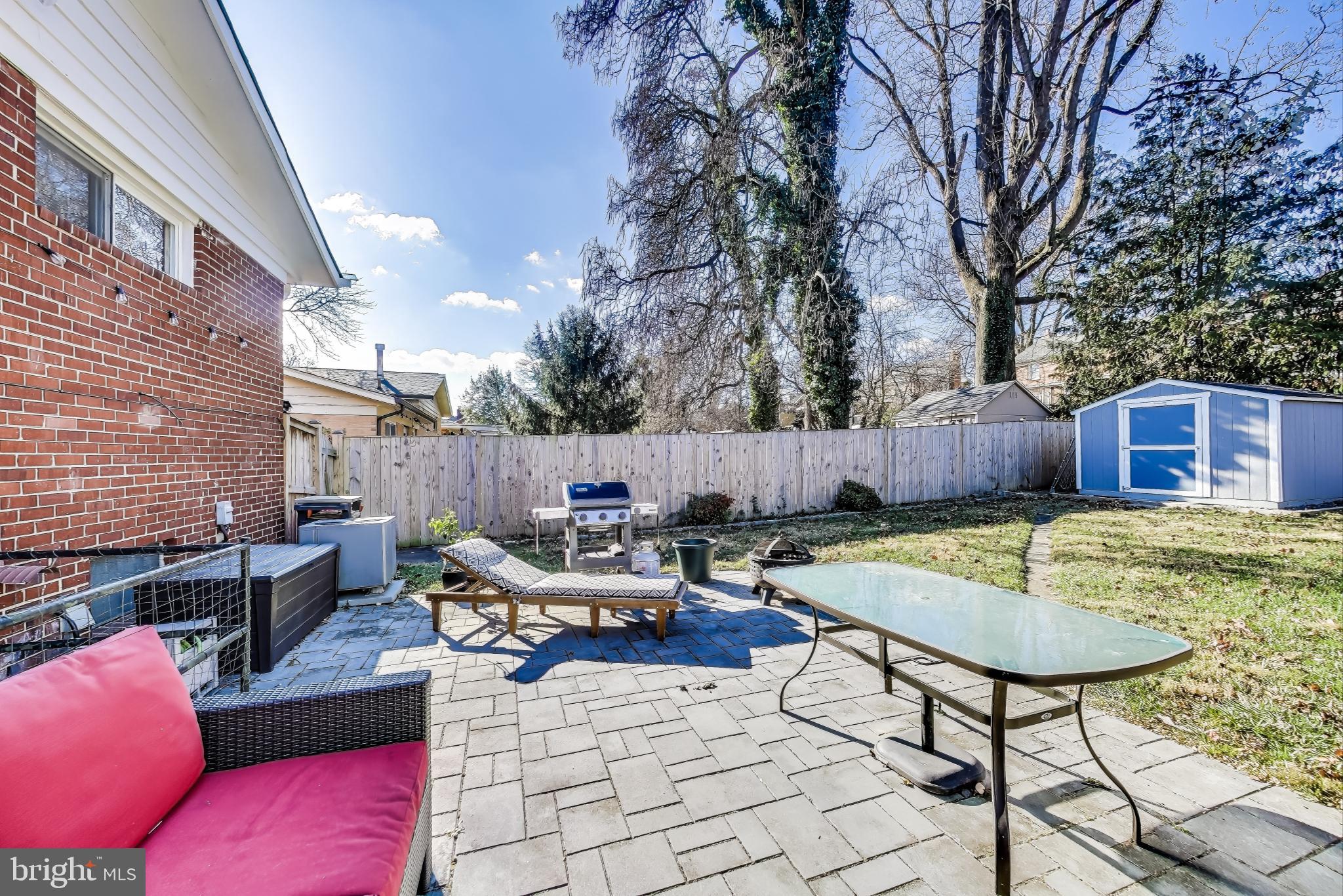 9512 Flower Avenue Silver Spring, MD 20901 - Photo 37 of 41 a backyard of a house with barbeque oven table and chairs