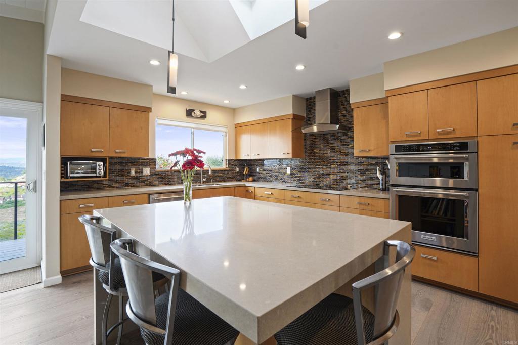 656 Canyon Drive Solana Beach, CA 92075 - Photo 14 of 29 a kitchen with stainless steel appliances granite countertop a sink a stove and a refrigerator