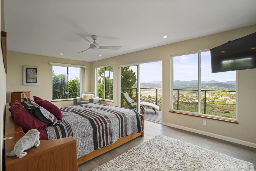 656 Canyon Drive Solana Beach, CA 92075 - Photo 18 of 29 a bed sitting in a spacious bedroom next to a window