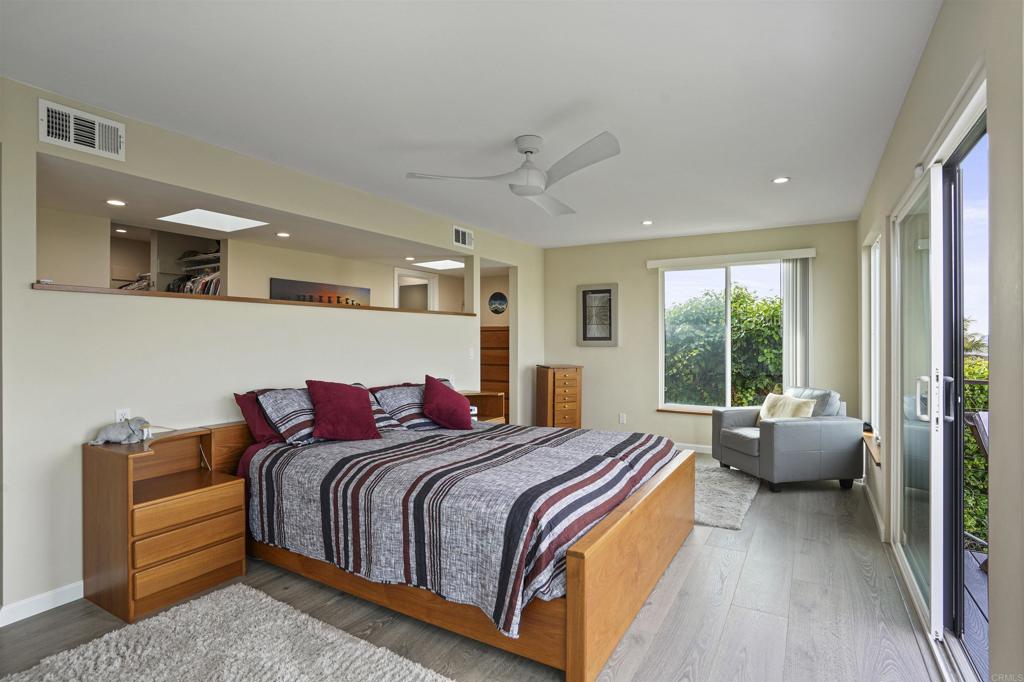 656 Canyon Drive Solana Beach, CA 92075 - Photo 20 of 29 a bedroom with bed and large windows