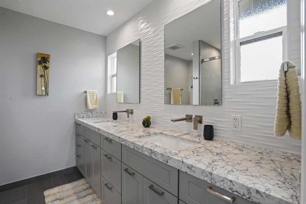 656 Canyon Drive Solana Beach, CA 92075 - Photo 21 of 29 a bathroom with a sink and a mirror