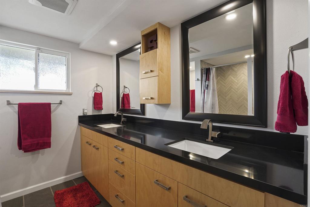 656 Canyon Drive Solana Beach, CA 92075 - Photo 24 of 29 a bathroom with a granite countertop double vanity sink and a mirror
