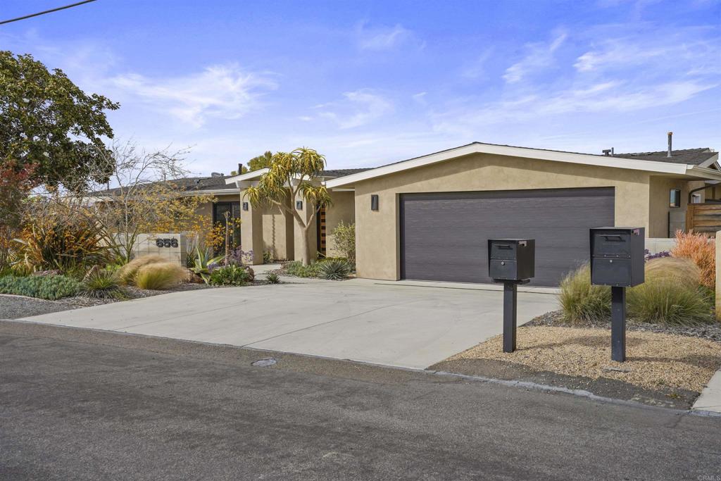 656 Canyon Drive Solana Beach, CA 92075 - Photo 4 of 29 a front view of a house with a yard and garage