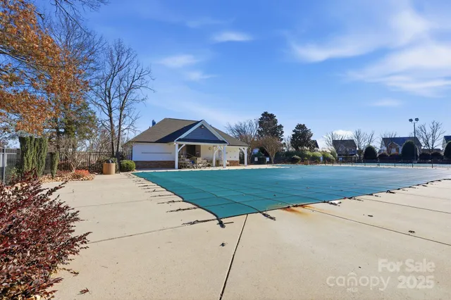 a front view of house with a garden and trees