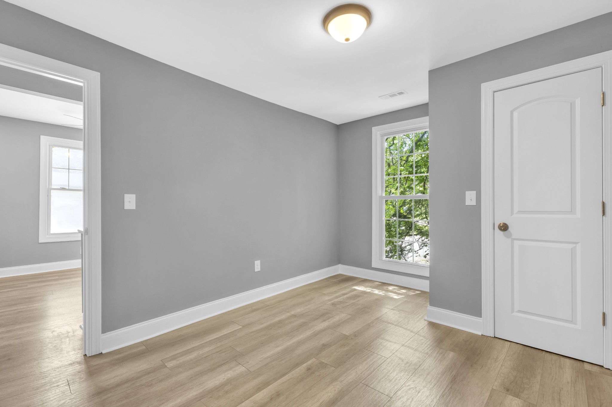 223 East 4th Avenue Springfield, TN 37172 - Photo 9 of 13 an empty room with wooden floor and windows