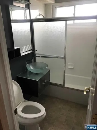 a bathroom with a toilet a sink and a mirror