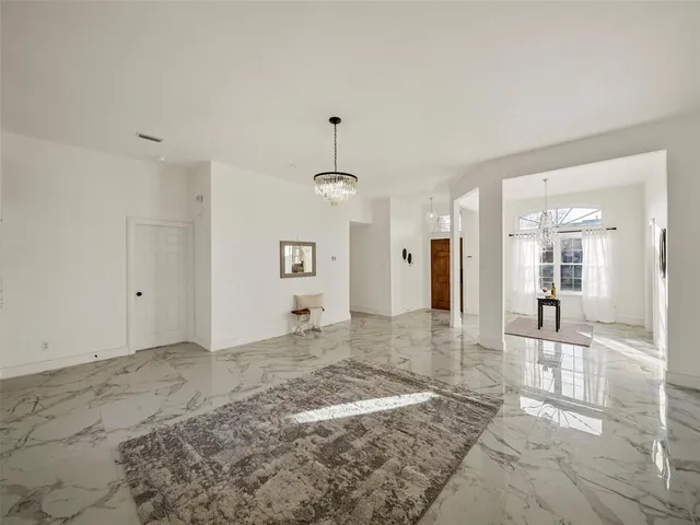 a view of a big room with wooden floor and a bathroom