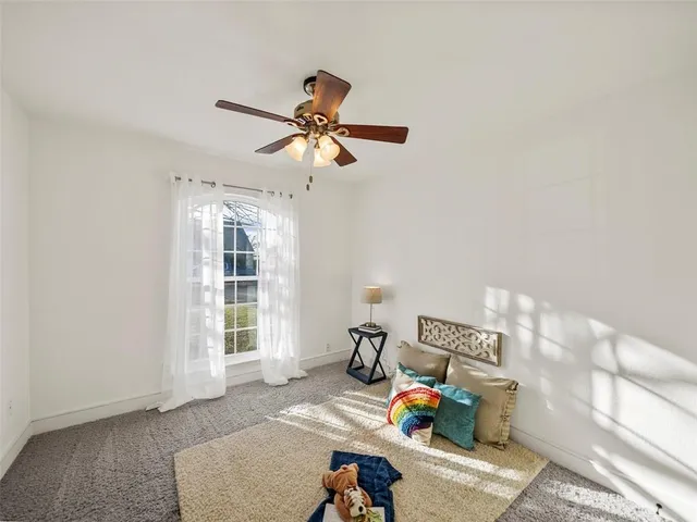 a bedroom with furniture and a window