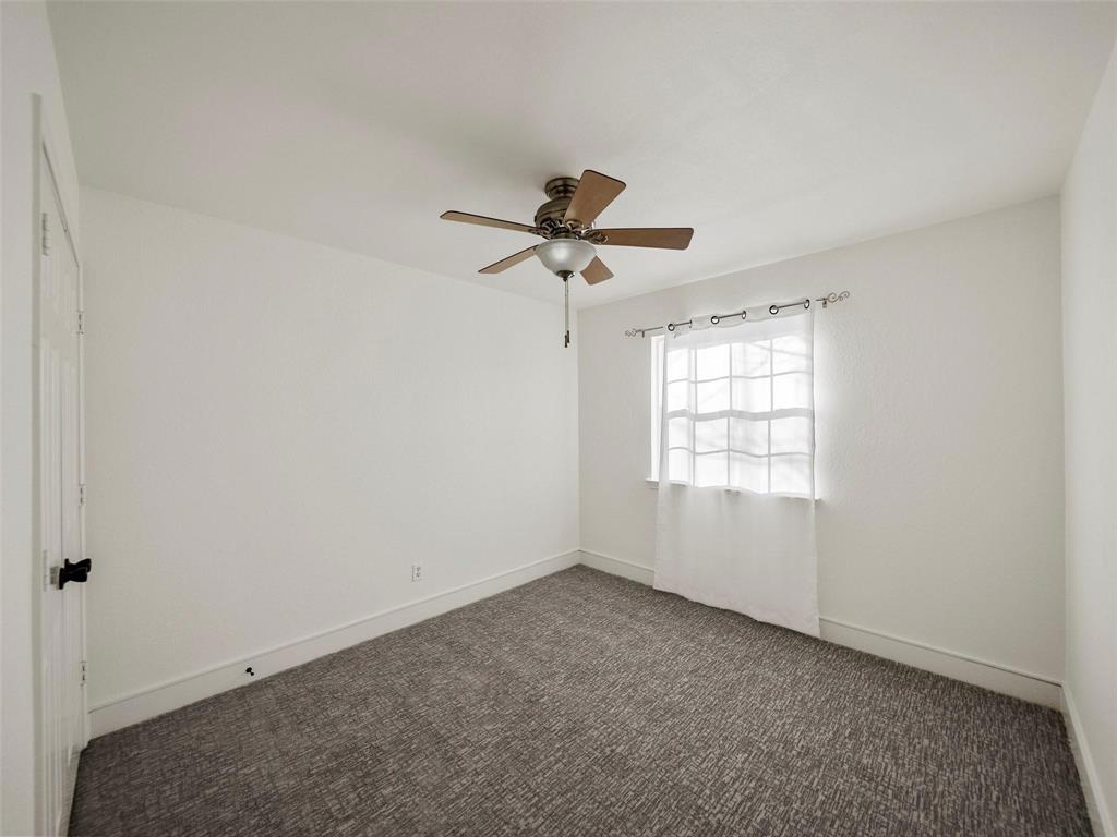 4818 Mize Court Rowlett, TX 75088 - Photo 14 of 21 an empty room with a window and a fan