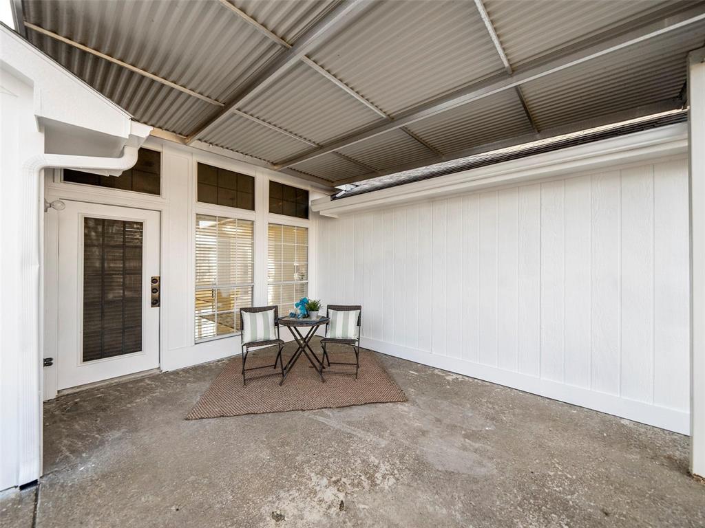 4818 Mize Court Rowlett, TX 75088 - Photo 17 of 21 a view of a patio with table and chairs and floor to ceiling window