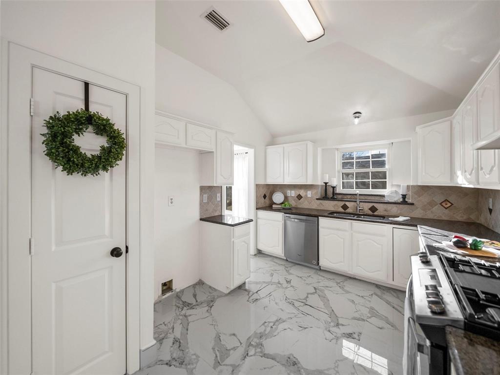 4818 Mize Court Rowlett, TX 75088 - Photo 6 of 21 a kitchen with stainless steel appliances kitchen island granite countertop a refrigerator and a sink
