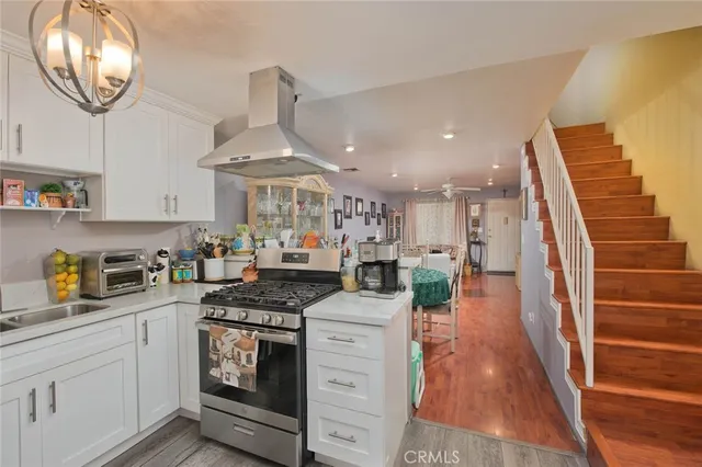 a kitchen with stainless steel appliances granite countertop a stove and cabinets
