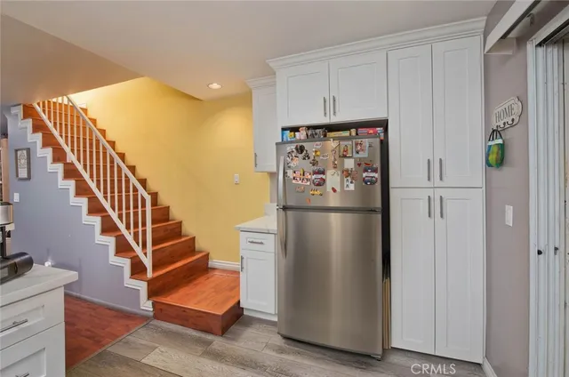 a view of kitchen with furniture and a refrigerator