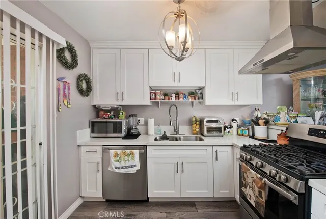 a kitchen with stainless steel appliances granite countertop a stove and cabinets