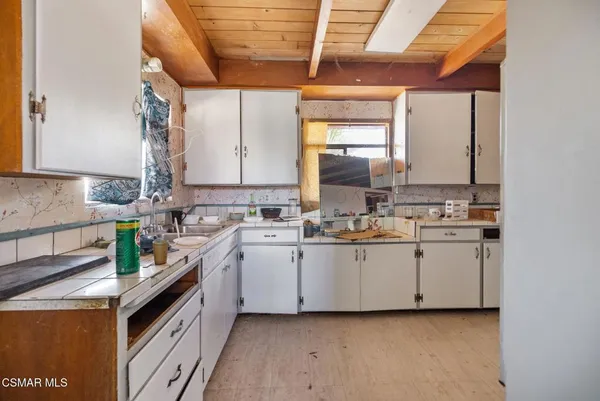 a kitchen with sink cabinets and window