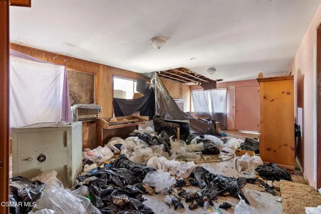 a view of a hallway with large glass door and furniture