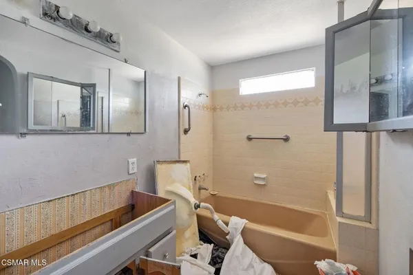 a bathroom with a tub and shower