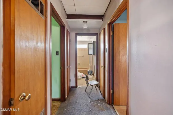 a view of a hallway with large glass door and furniture
