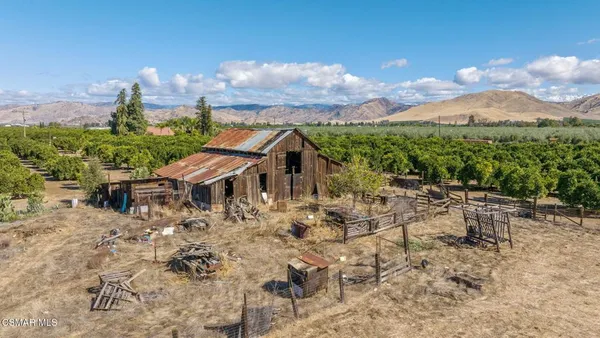 a view of a house with a yard and sitting area