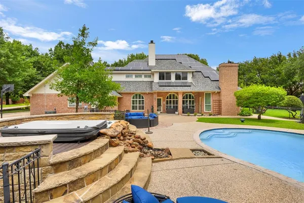 a view of a house with swimming pool and sitting area
