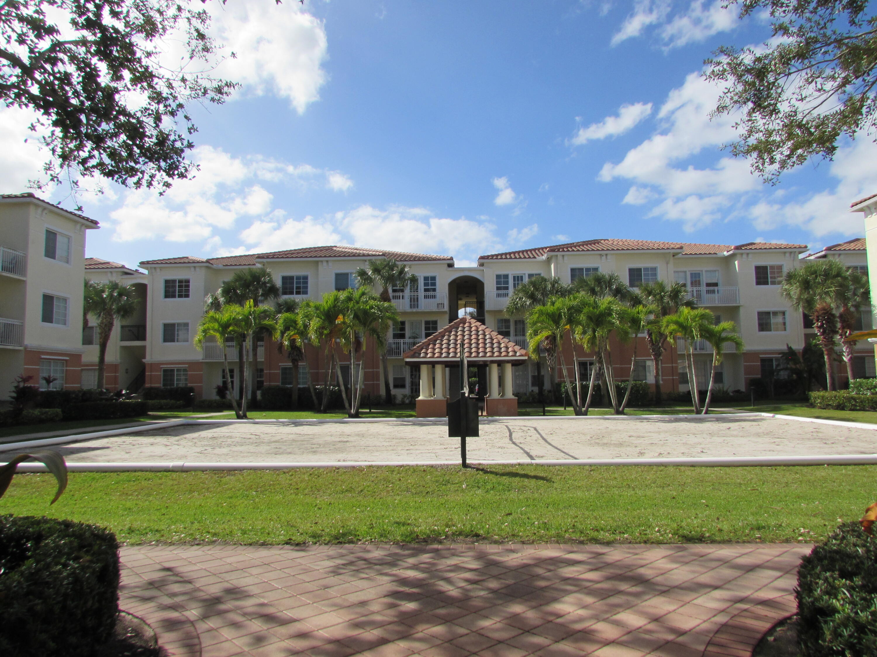 9873 Baywinds Boulevard, Unit 5107 West Palm Beach, FL 33411 - Photo 17 of 22 a outdoor space with lots of palm trees