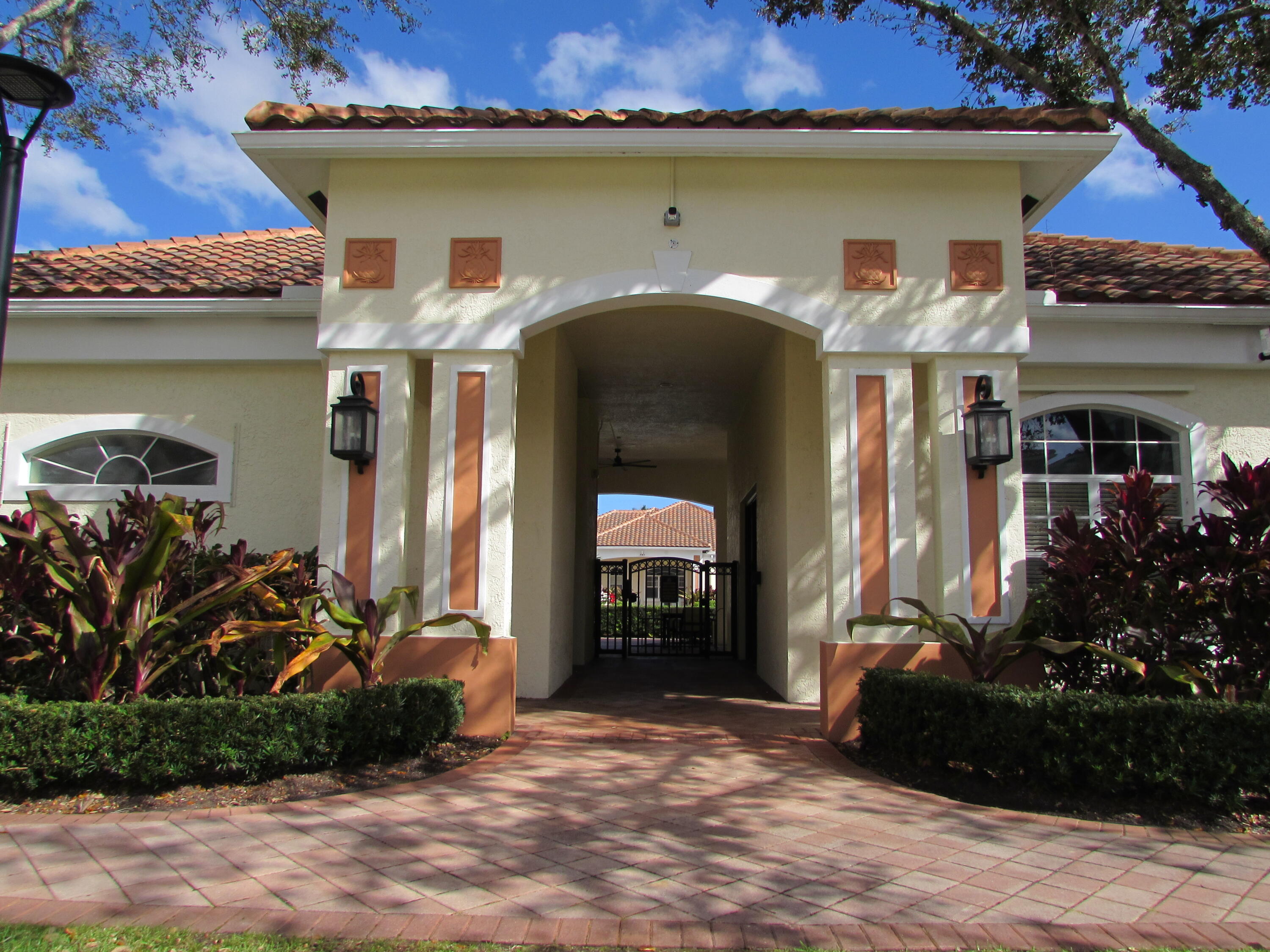 9873 Baywinds Boulevard, Unit 5107 West Palm Beach, FL 33411 - Photo 18 of 22 a front view of a house with garden