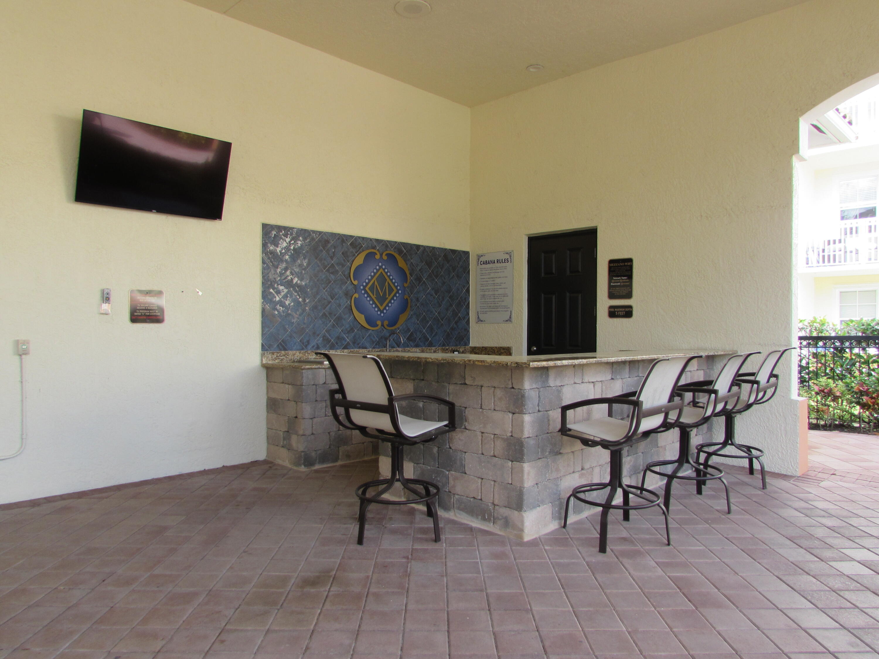 9873 Baywinds Boulevard, Unit 5107 West Palm Beach, FL 33411 - Photo 20 of 22 a view of a livingroom with furniture and a flat screen tv