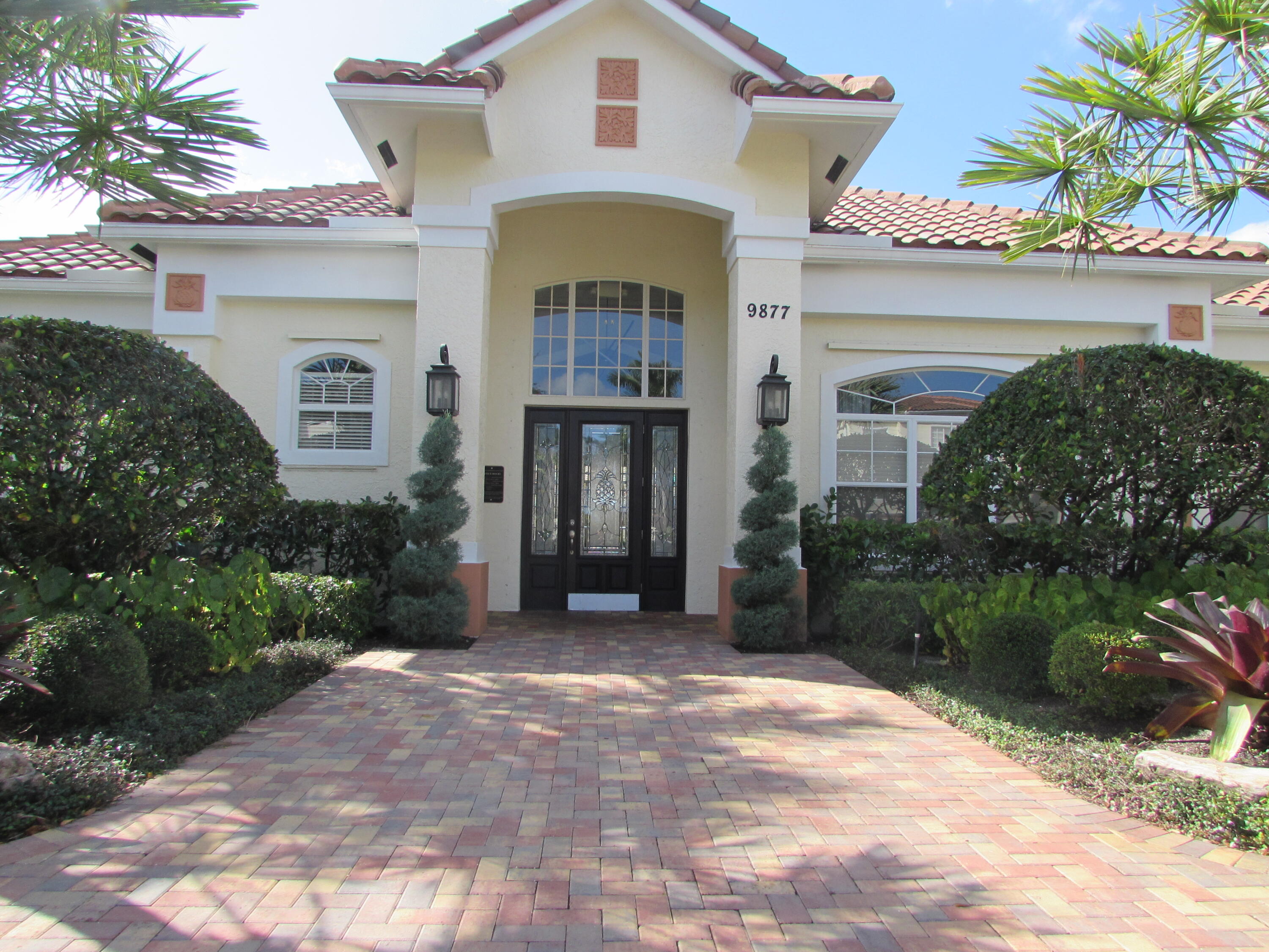 9873 Baywinds Boulevard, Unit 5107 West Palm Beach, FL 33411 - Photo 22 of 22 a front view of a house with a yard