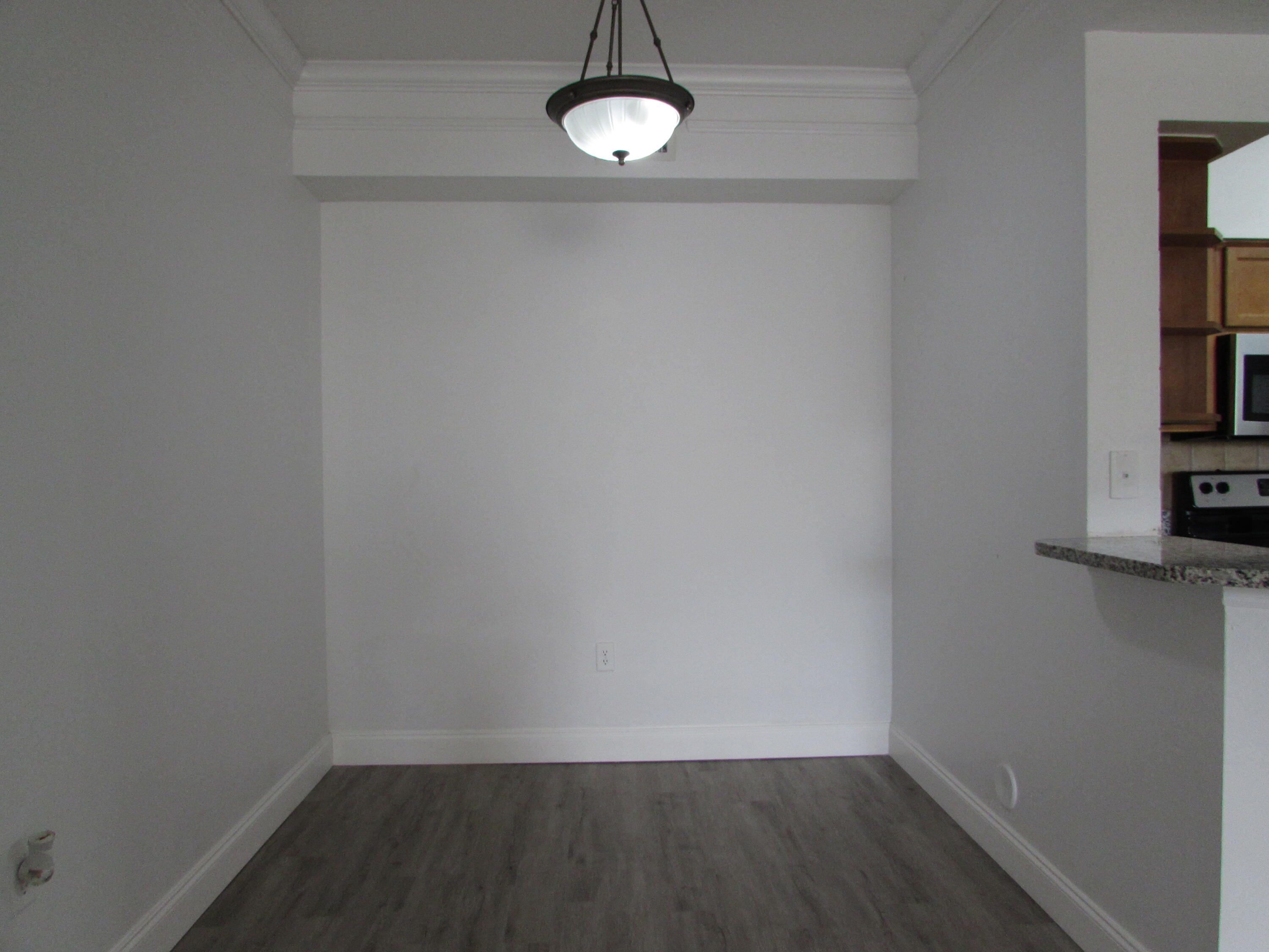 9873 Baywinds Boulevard, Unit 5107 West Palm Beach, FL 33411 - Photo 7 of 22 a view of a room with rack and wooden floor