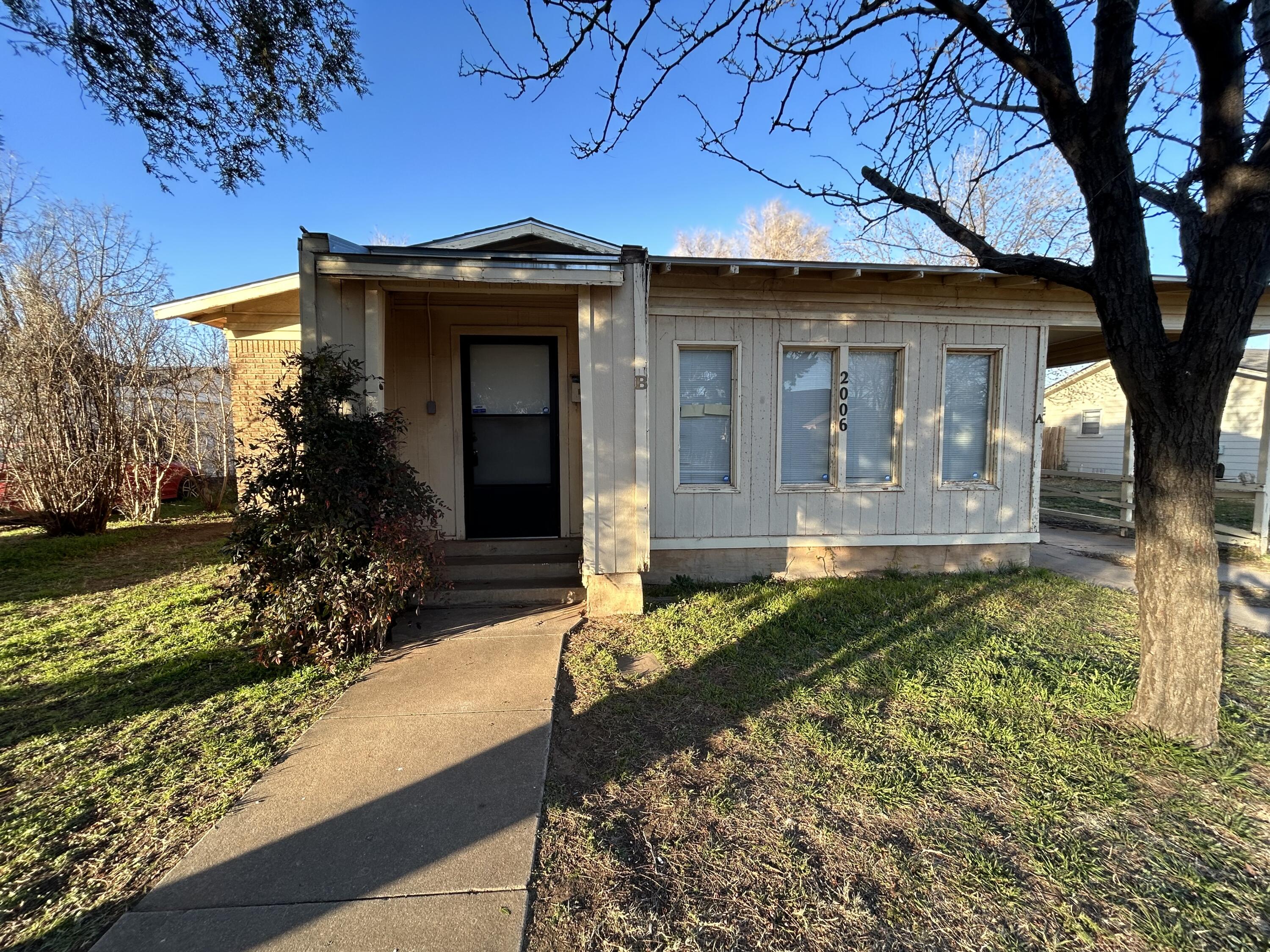 2006 28th Street, Unit B Lubbock, TX 79411 - Photo 1 of 5 a front view of a house with garden