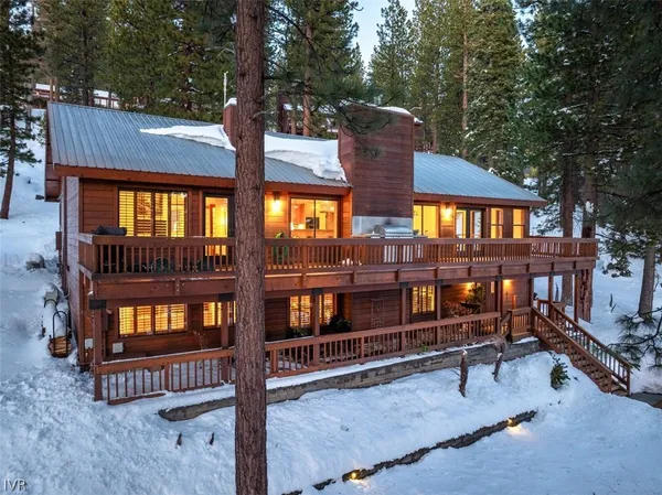 a view of a house with a wooden fence
