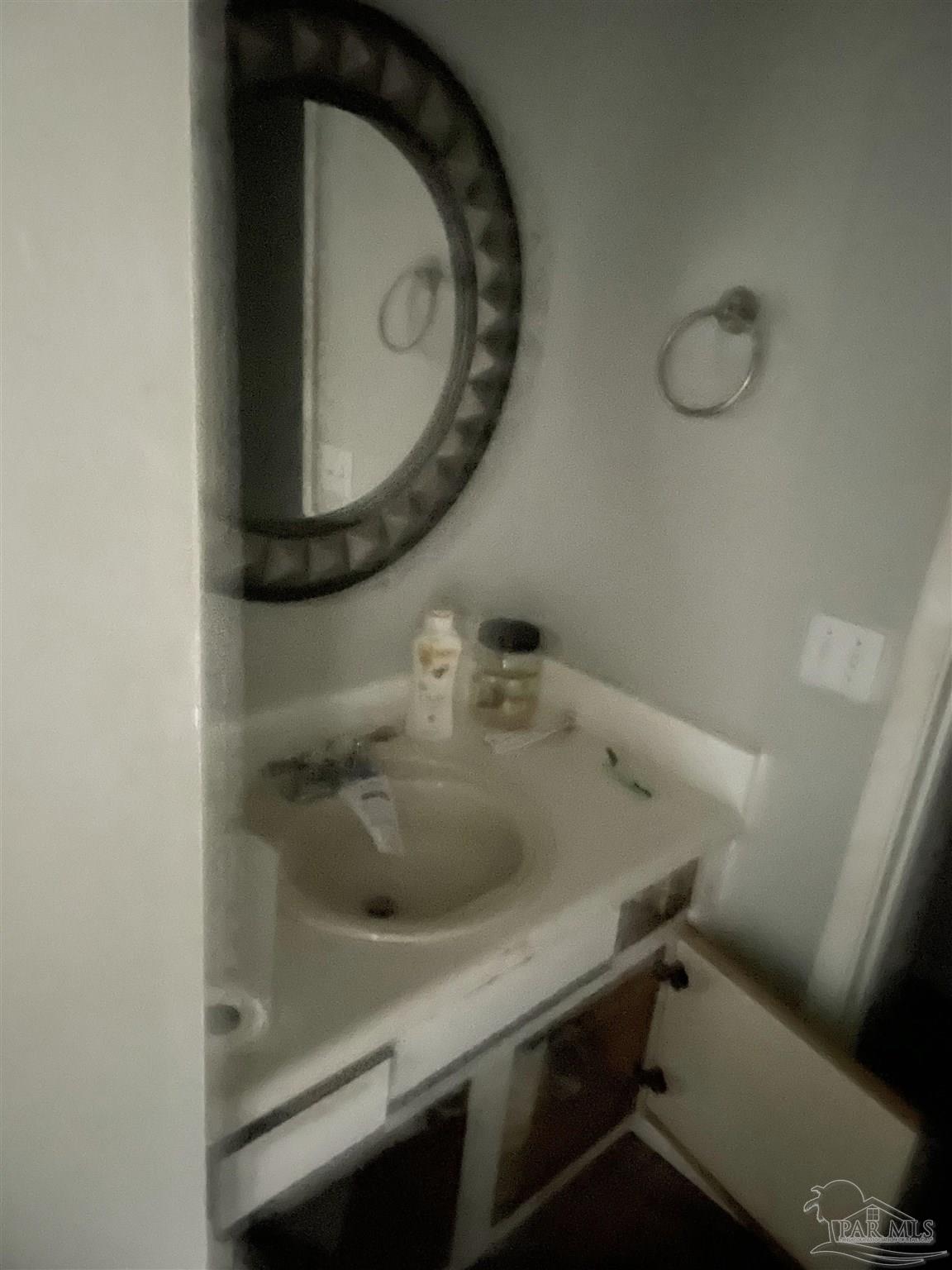 7150 Plantation Road, Unit 327 Pensacola, FL 32504 - Photo 16 of 24 a bathroom with a sink and a mirror