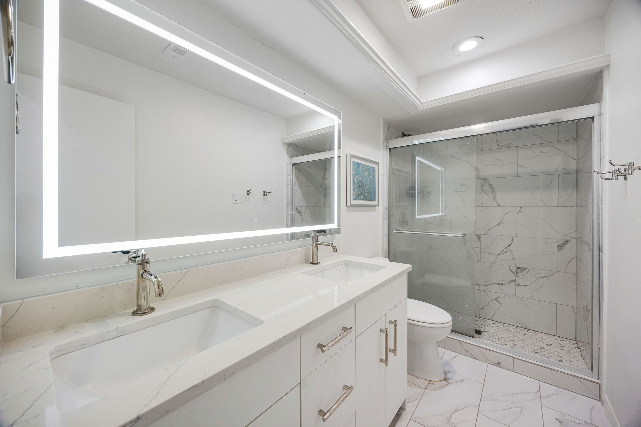 727 Bunker Hill Road, Unit 26 Houston, TX 77024 - Photo 19 of 25 The full bathroom is located in the hallway and was completely updated with new cabinetry, counters, tile flooring and LED mirror.