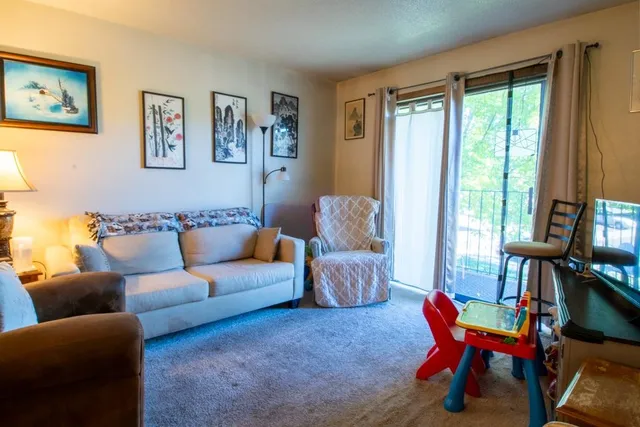 a living room with furniture and a large window