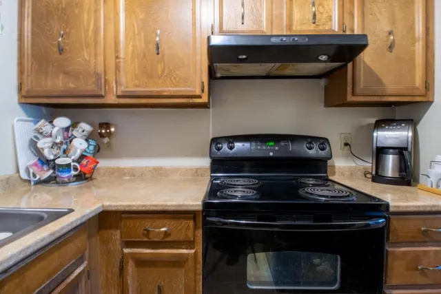 a kitchen with a stove and cabinets