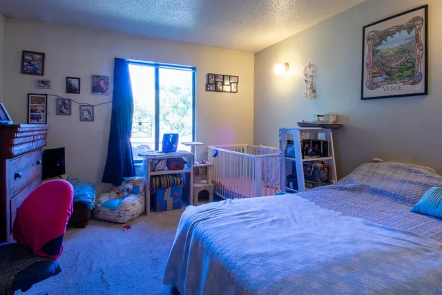 a bed room with a bed and a chair