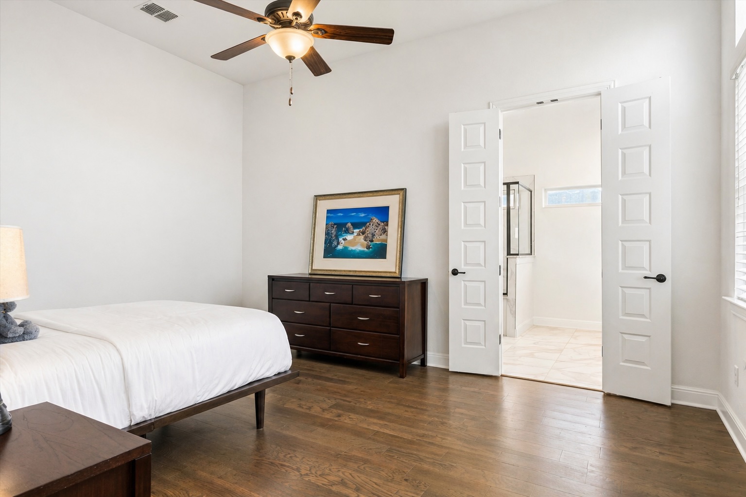 209 Rainier Drive Kyle, TX 78640 - Photo 7 of 24 Hardwood flooring throughout, bright white walls, and a ceiling fan with integrated lighting