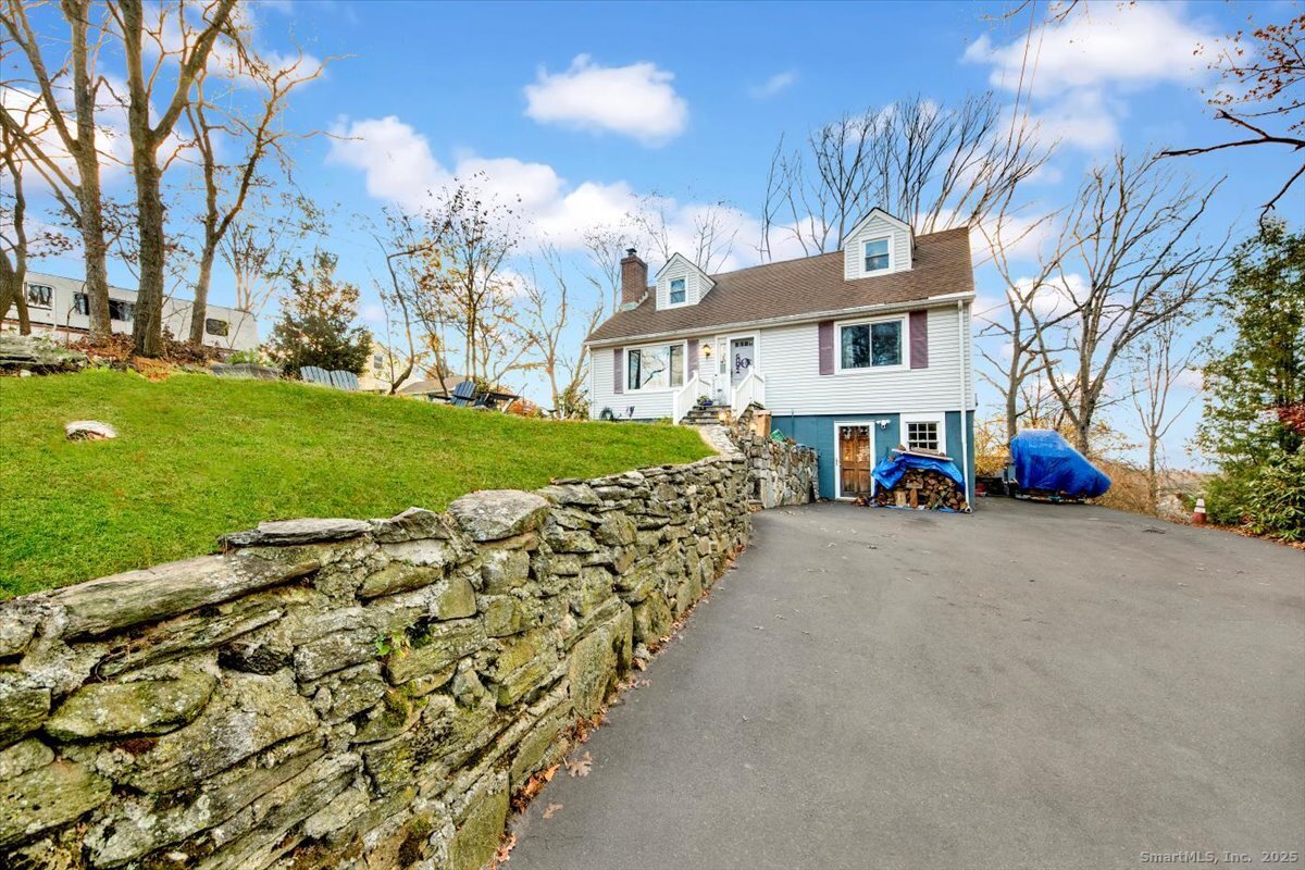 a view of a big house with a yard and large trees